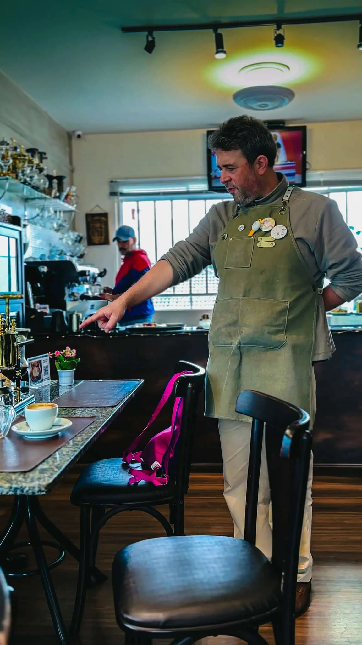 A barista conducting a coffee tasting session in a coffee shop in Curitiba, Brazil.