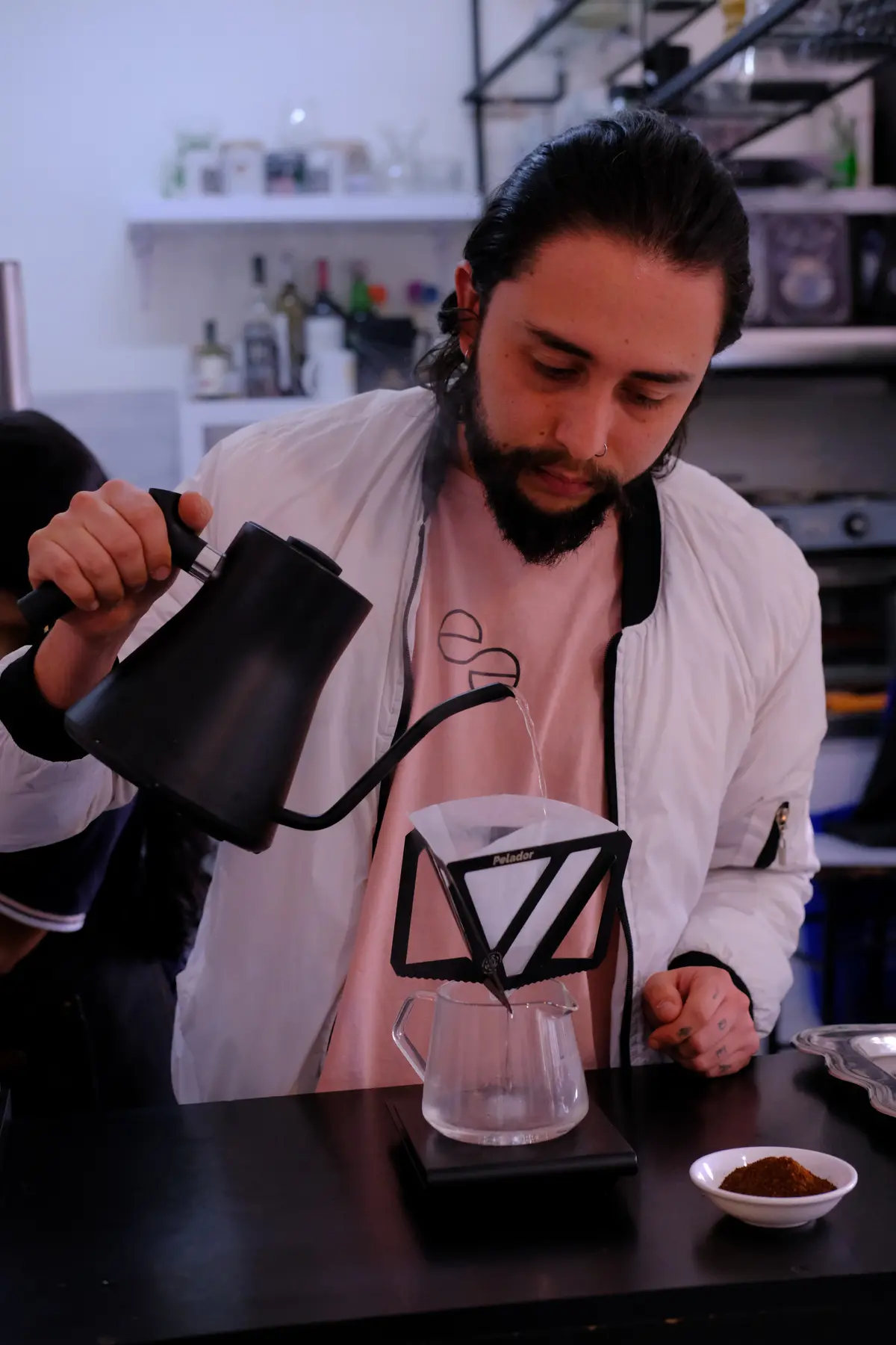 Barista preparing coffee during a workshop in Chapinero, Bogota food tour